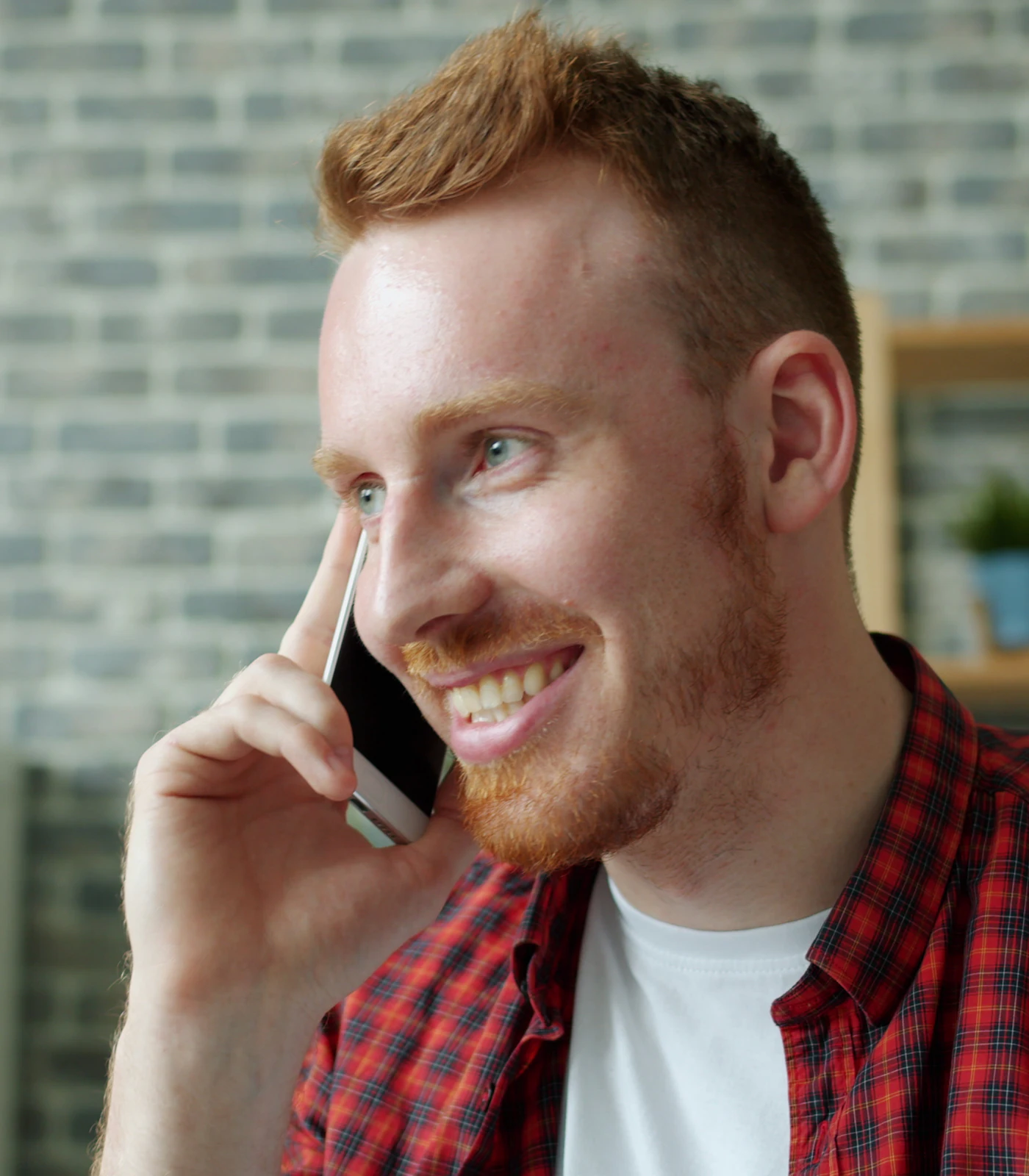 Smiling tradesman taking a call from a new customer