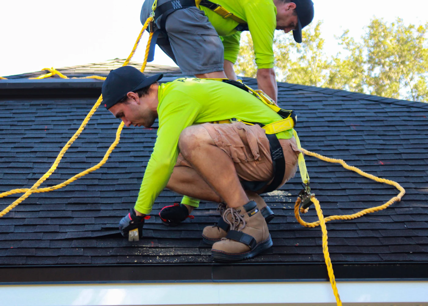 Roofing crew installing shingles