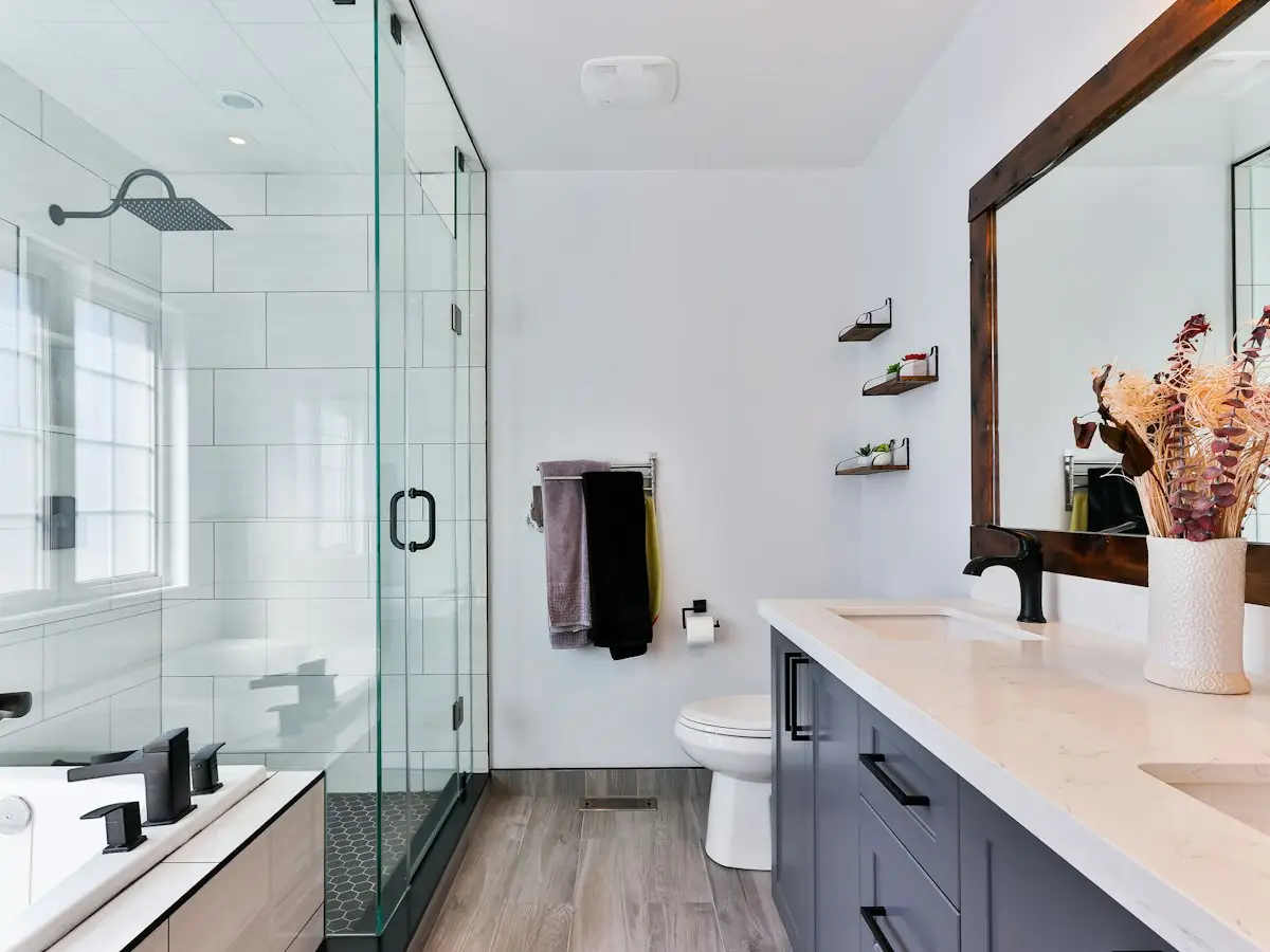 Remodeled bathroom with glass shower and double vanity