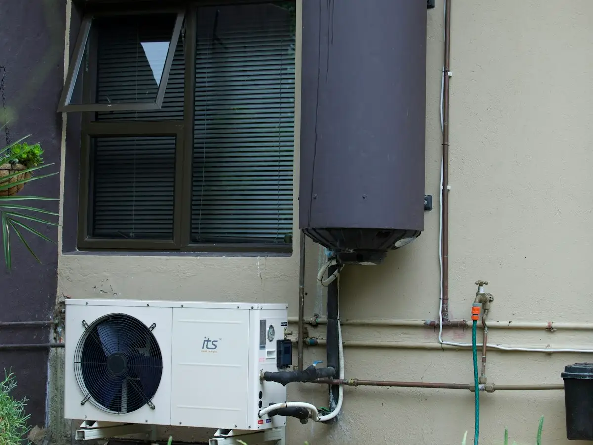 Outdoor AC unit next to a home water heater