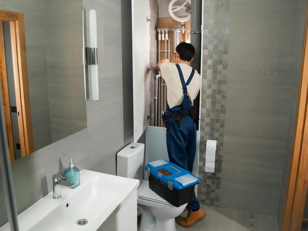 Plumber working in a home bathroom
