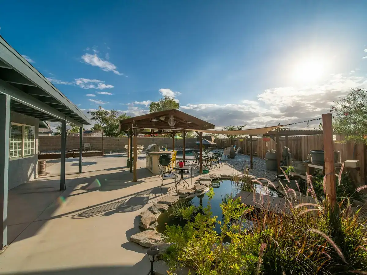Backyard with a stone pond and covered pavilion