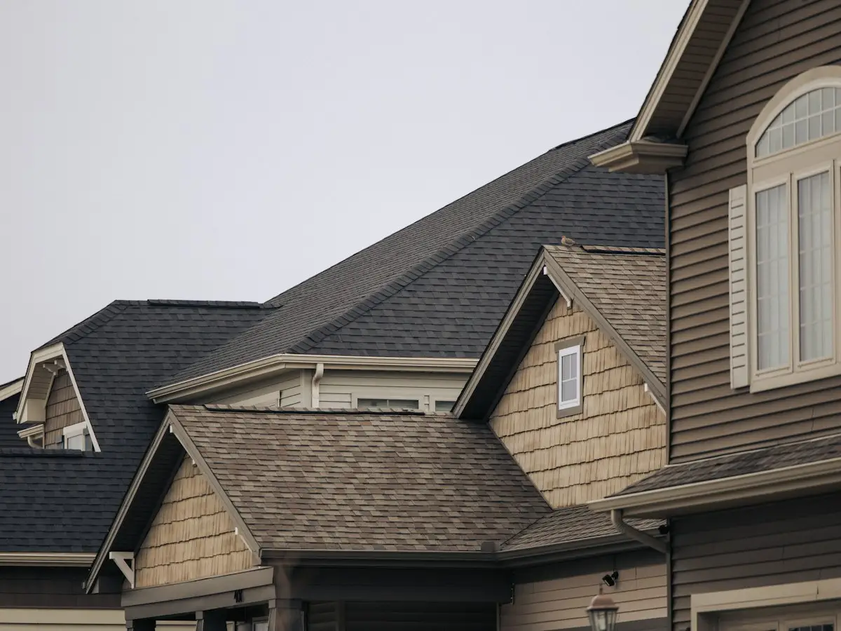 Row of homes with new shingle roofs and gutters