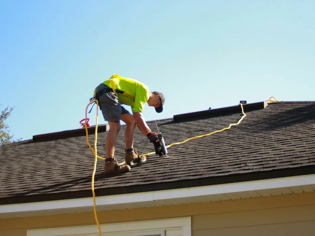 Summit roofer installing shingles with a nail gun