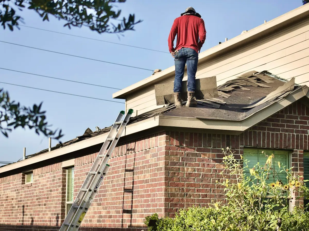 Roofer on a storm-damaged brick home